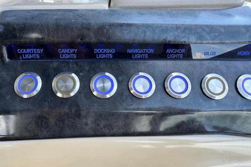 Slide: The Image of Control panel of a 2017 Regency 254 LE3 boat with labeled light switches. - 13