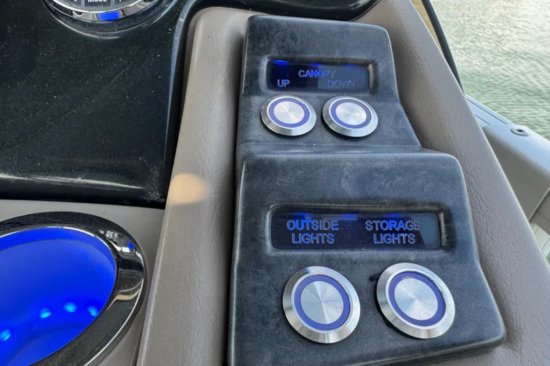 Slide: The Image of Control panel of 2017 Regency 254 LE3 boat with illuminated buttons and switches. - 14