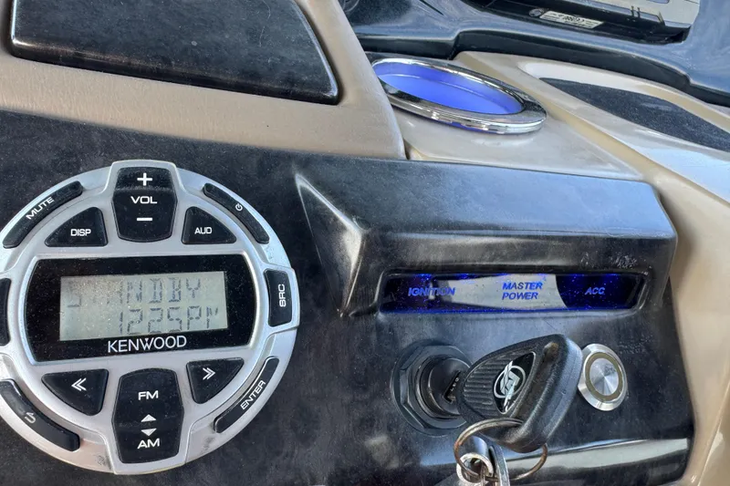 Slide: The Image of Dashboard of a 2017 Regency 254 LE3 with Kenwood stereo and ignition key. - 15
