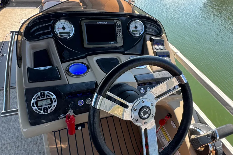 Slide: The Image of Steering console of 2017 Regency 254 LE3 boat with gauges and controls. - 16