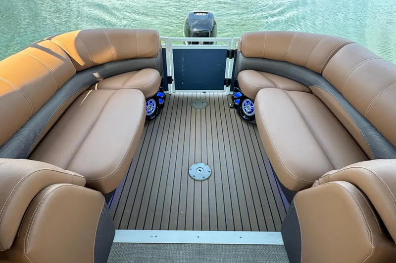 Slide: The Image of 2017 Regency 254 LE3 pontoon boat interior with tan seating and wood-style flooring. - 18