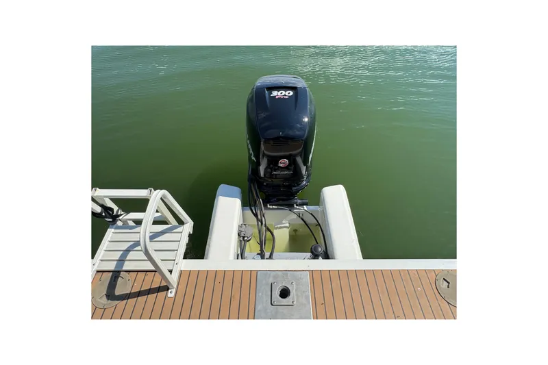 Slide: The Image of 2017 Regency 254 LE3 boat with powerful outboard motor on calm water. - 21