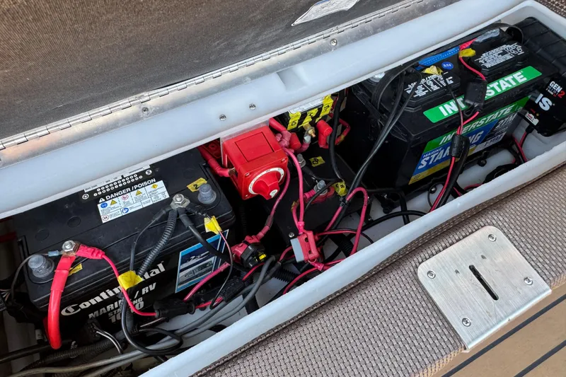 Slide: The Image of Battery compartment of a 2017 Regency 254 LE3 boat with multiple connected batteries. - 23