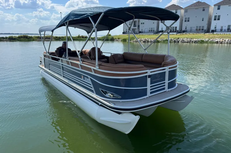 Slide: The Image of 2017 Regency 254 LE3 pontoon boat on calm water, featuring a canopy and comfortable seating. - 4