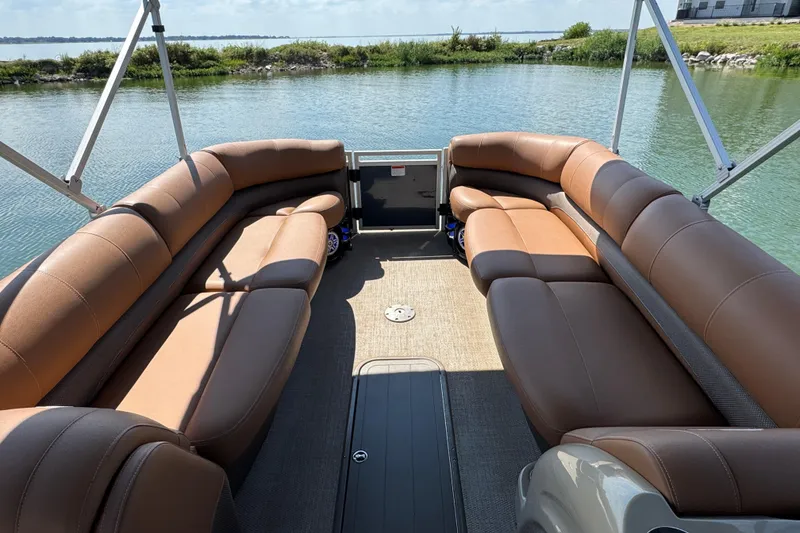Slide: The Image of Luxurious seating on 2017 Regency 254 LE3 pontoon boat, docked by serene water. - 6