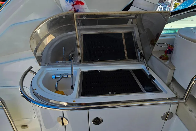 Slide: The Image of 2009 Cobalt 373 yacht kitchenette with sink and grill, featuring sleek design and modern amenities. - 12