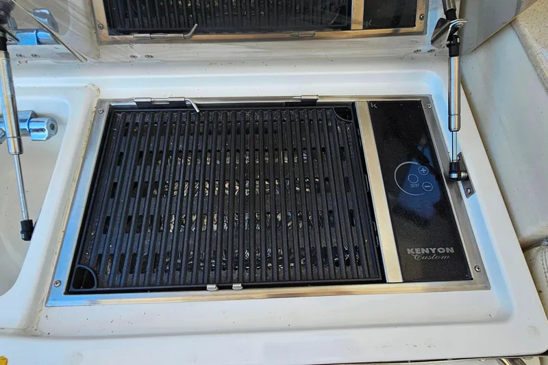 Slide: The Image of Kenyon Custom grill on 2009 Cobalt 373 boat, featuring sleek design and controls. - 13