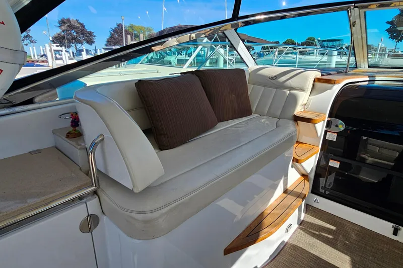 Slide: The Image of Luxurious interior of 2009 Cobalt 373 boat with white seating and brown cushions. - 16