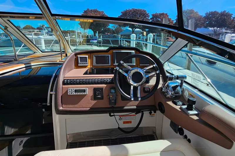 Slide: The Image of 2009 Cobalt 373 boat helm with steering wheel, controls, and navigation equipment. - 18