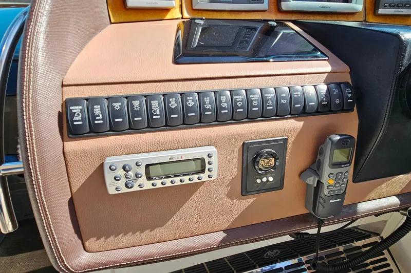 Slide: The Image of Control panel of a 2009 Cobalt 373 boat with switches and communication devices. - 20
