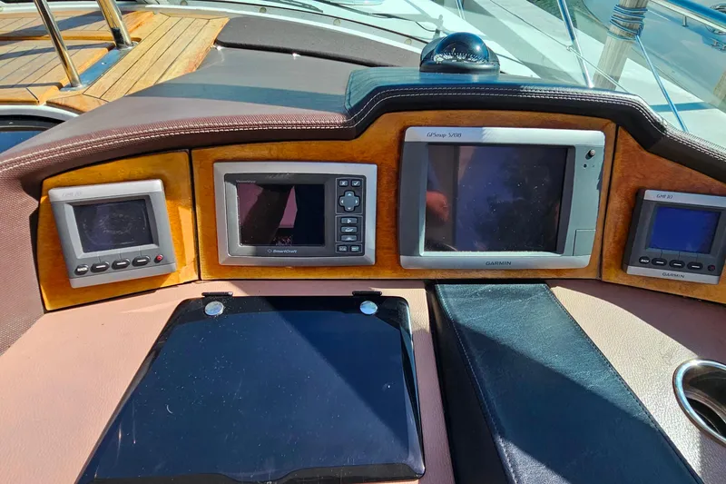 Slide: The Image of Dashboard of a 2009 Cobalt 373 boat with navigation and control displays. - 21