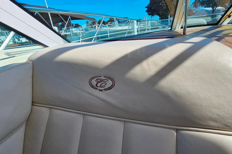 Slide: The Image of 2009 Cobalt 373 boat interior with embroidered logo on beige upholstery. - 25