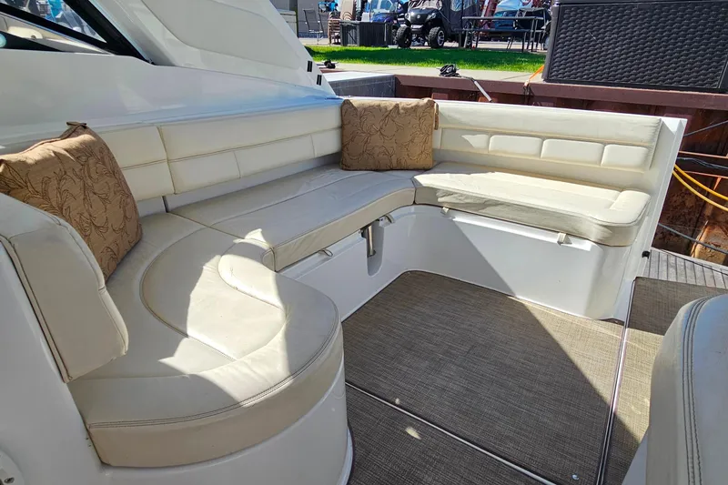 Slide: The Image of Luxurious seating area on a 2009 Cobalt 373 yacht with beige cushions and pillows. - 28