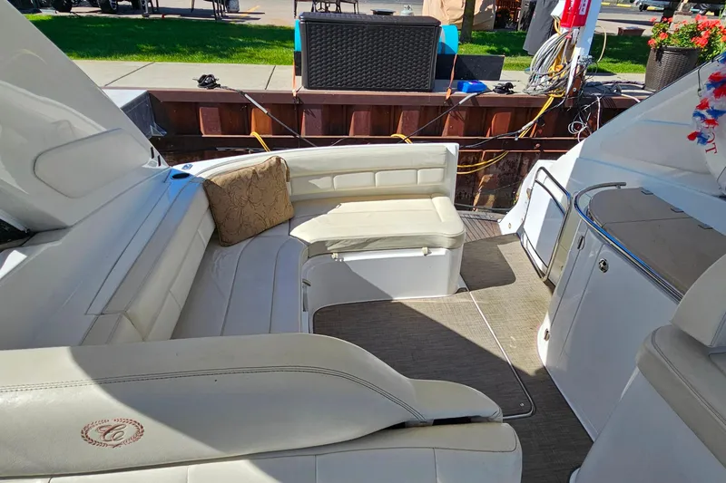 Slide: The Image of Interior of a 2009 Cobalt 373 boat with white seating and a decorative pillow. - 29