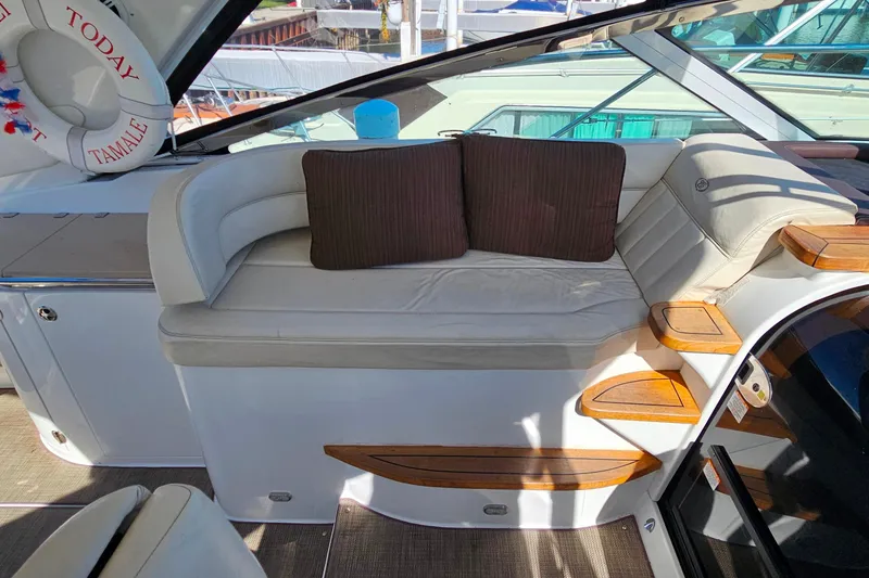 Slide: The Image of Luxurious seating area on a 2009 Cobalt 373 boat with cushions and wooden accents. - 31