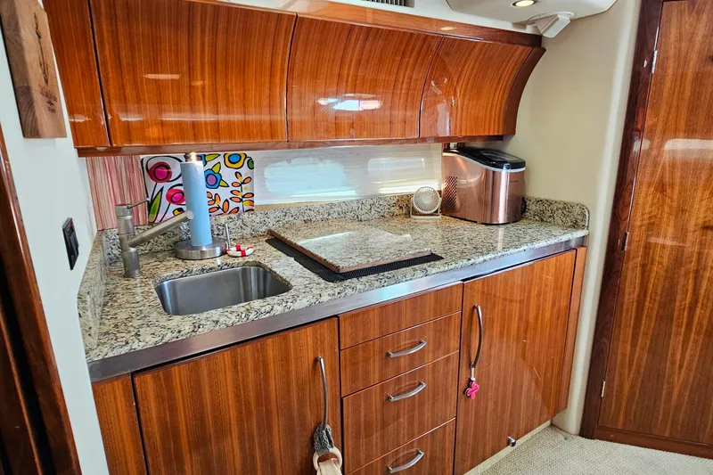 Slide: The Image of Luxurious 2009 Cobalt 373 yacht kitchen with granite countertops and wooden cabinetry. - 36