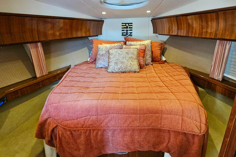 Slide: The Image of Luxurious cabin interior of a 2009 Cobalt 373 with plush bedding and wood accents. - 39