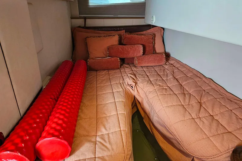 Slide: The Image of Interior cabin of 2009 Cobalt 373 with cozy bedding and red cushions. - 42