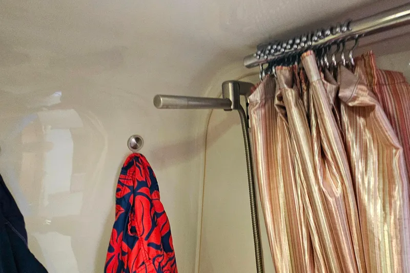 Slide: The Image of Interior of 2009 Cobalt 373 with hanging clothes and striped curtain. - 45