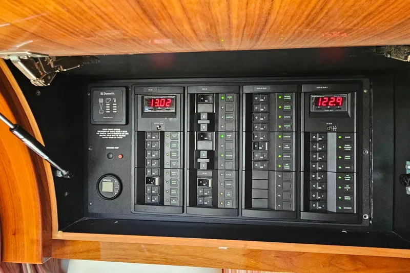 Slide: The Image of Electrical control panel in a 2009 Cobalt 373 boat, featuring switches and digital displays. - 46