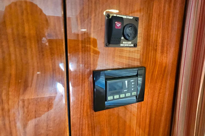 Slide: The Image of Wooden panel with control switches on a 2009 Cobalt 373 boat. - 48