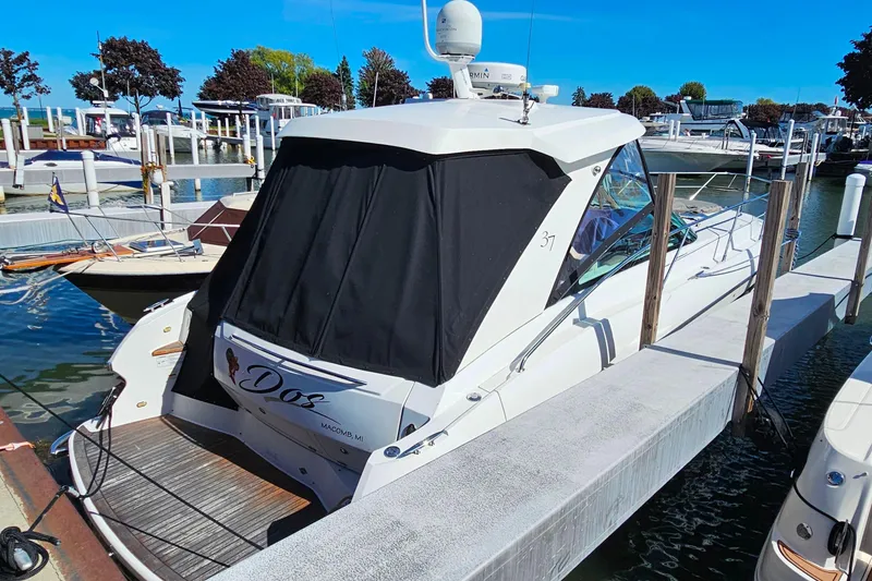 Slide: The Image of 2009 Cobalt 373 boat docked at marina under clear blue sky. - 5