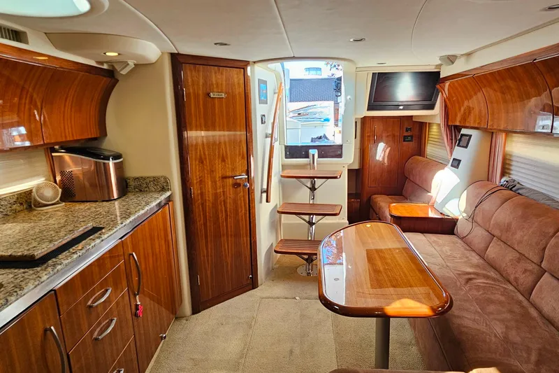 Slide: The Image of Luxurious 2009 Cobalt 373 yacht interior with wood finishes, granite countertops, and plush seating. - 50
