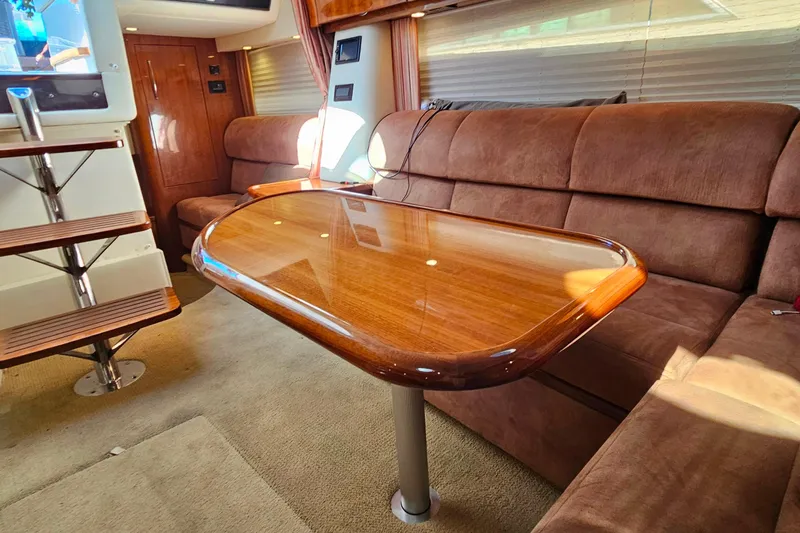 Slide: The Image of Luxurious interior of a 2009 Cobalt 373 yacht with polished wood table and plush seating. - 52