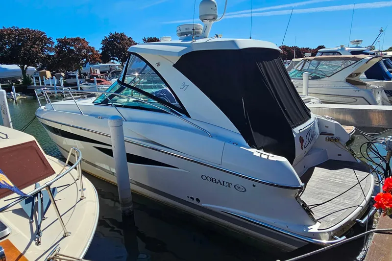 Slide: The Image of 2009 Cobalt 373 boat docked at marina under clear blue sky. - 55