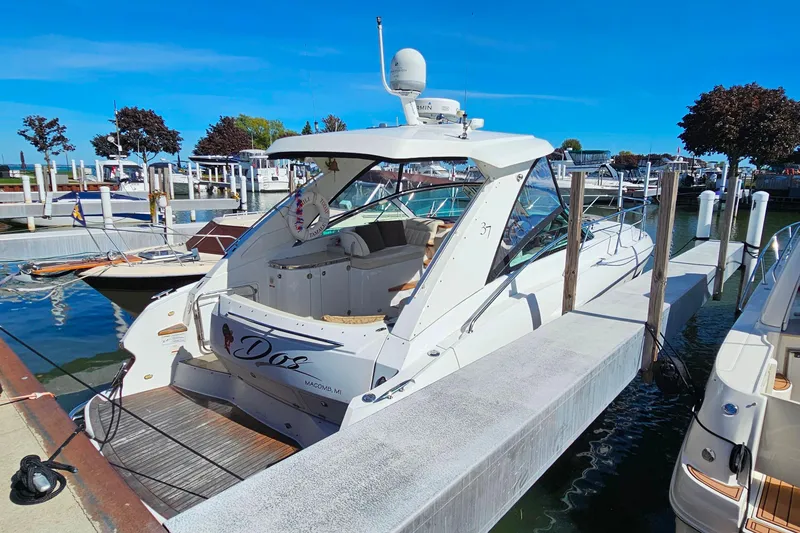 Slide: The Image of 2009 Cobalt 373 boat docked at marina under clear blue sky. - 56
