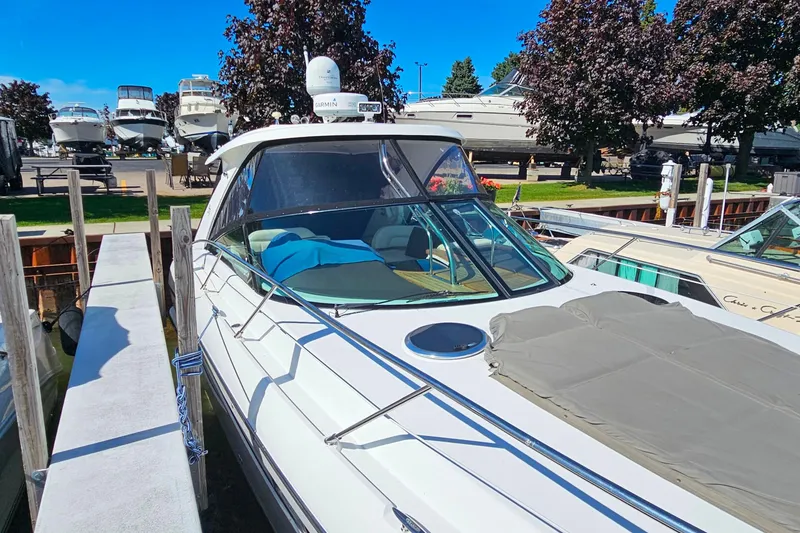 Slide: The Image of 2009 Cobalt 373 boat docked at marina, surrounded by other vessels and trees. - 8
