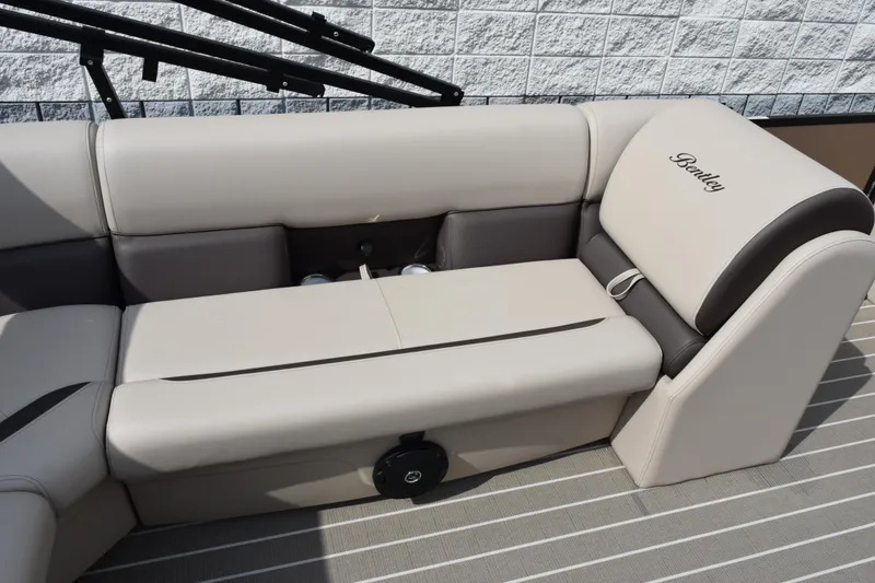 Slide: The Image of 2026 Bentley Pontoons Legacy 223 Cruise XL interior seating, featuring luxurious beige and brown upholstery. - 10
