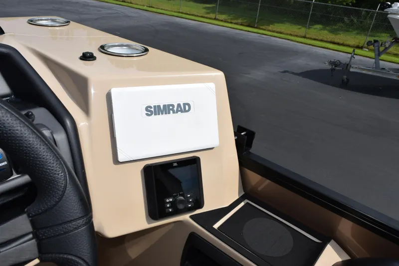 Slide: The Image of 2026 Bentley Pontoons Legacy 223 Cruise XL dashboard with Simrad display and JBL controls. - 16