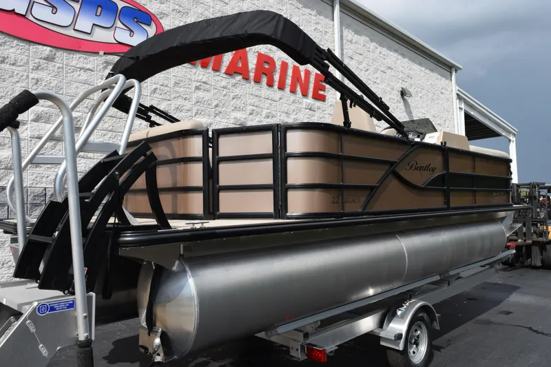 Slide: The Image of 2026 Bentley Pontoons Legacy 223 Cruise XL displayed outside a marine dealership. - 4