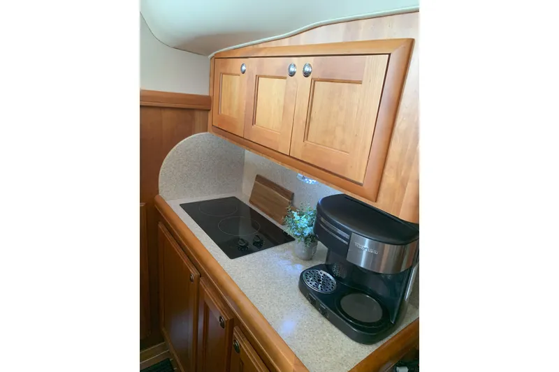 Slide: The Image of stove, coffee maker, and wooden cabinets - 33