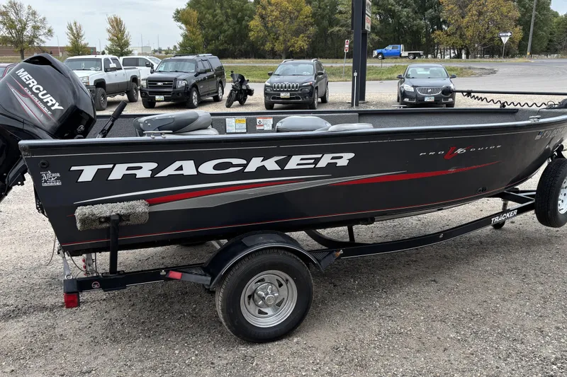 Slide: The Image of 2015 Tracker Pro Guide V-16 T boat on trailer in parking lot. - 4