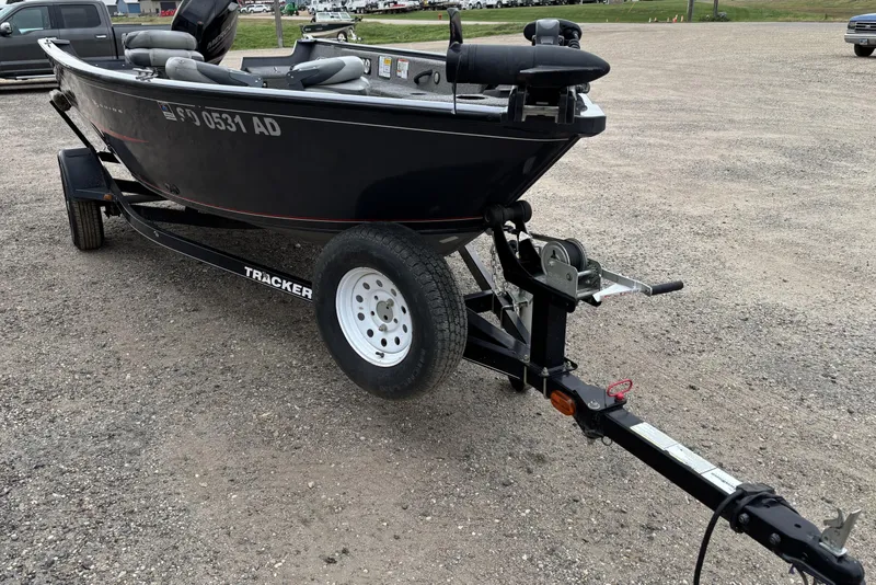 Slide: The Image of 2015 Tracker Pro Guide V-16 T boat on trailer in parking lot. - 5