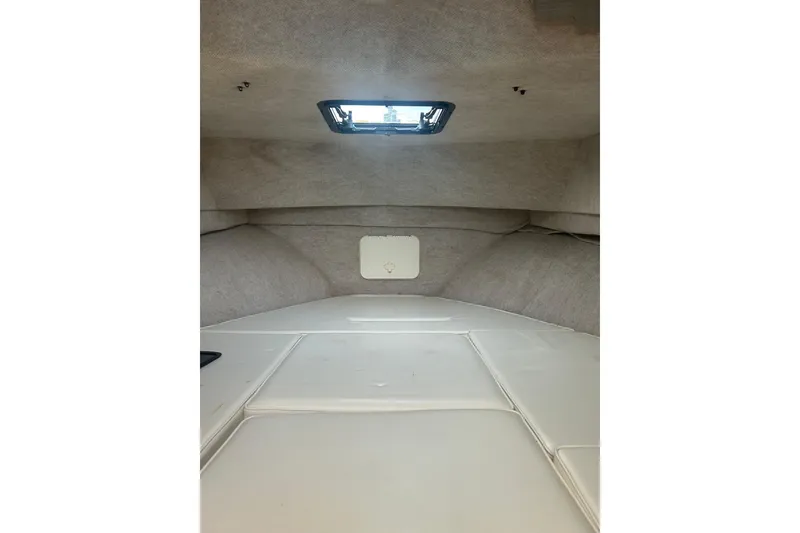 Slide: The Image of Interior cabin of 2004 Parker 2510 Modified Vee Walkaround boat, featuring a compact, cozy design. - 10