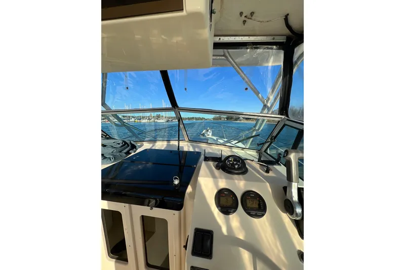 Slide: The Image of 2004 Parker 2510 Modified Vee Walkaround boat interior with dashboard view. - 13