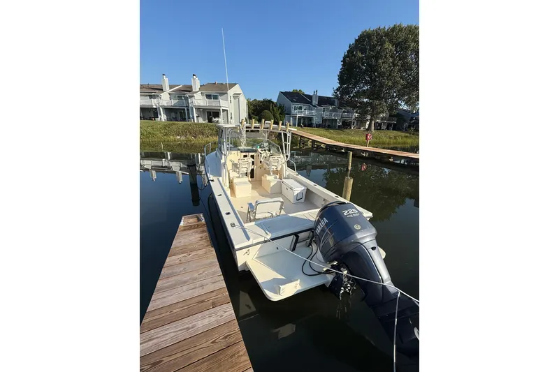 Slide: The Image of 2004 Parker 2510 Modified Vee Walkaround boat docked, featuring Yamaha 225 engine. - 5