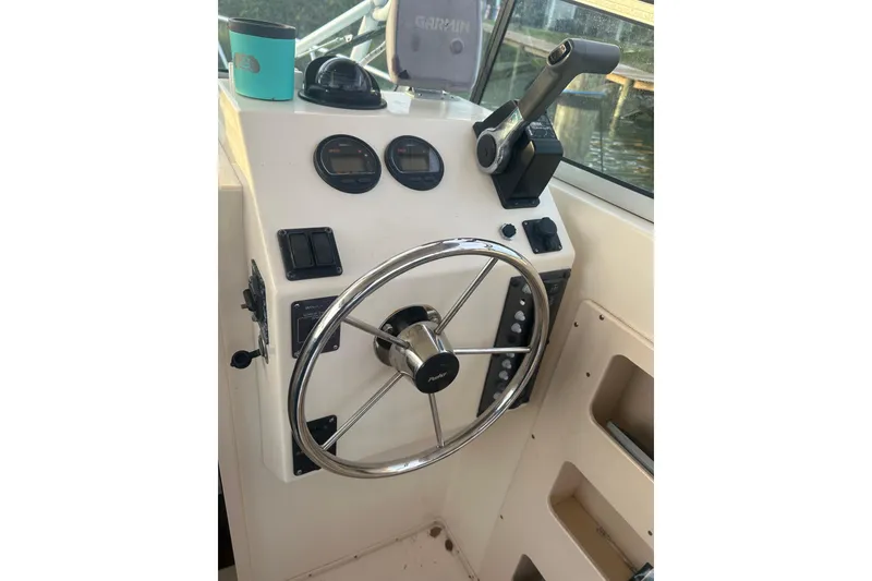 Slide: The Image of Control panel of 2004 Parker 2510 Modified Vee Walkaround boat with steering wheel and gauges. - 7