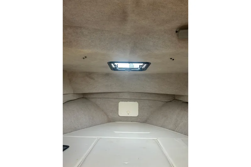 Slide: The Image of Interior cabin of 2004 Parker 2510 Modified Vee Walkaround boat, featuring a hatch window. - 9