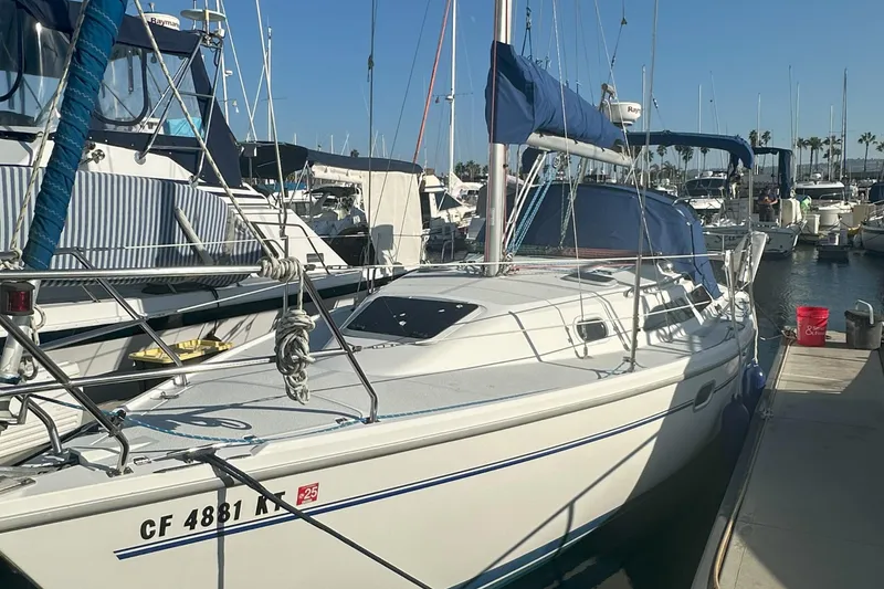 Slide: The Image of 2001 Catalina 28 MkII sailboat docked in a marina under clear blue skies. - 12