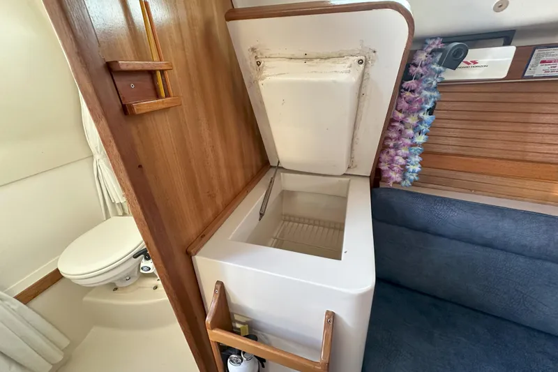 Slide: The Image of 2001 Catalina 28 MkII interior with open storage compartment and adjacent toilet. - 18
