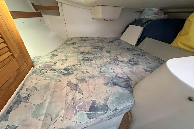 Slide: The Image of Interior cabin of 2001 Catalina 28 MkII sailboat with patterned bedding. - 19