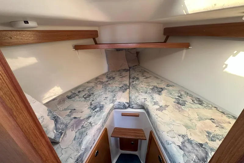 Slide: The Image of Cozy cabin interior of 2001 Catalina 28 MkII sailboat with patterned bedding. - 20