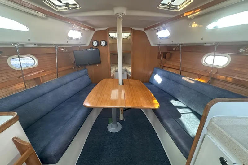 Slide: The Image of Interior of 2001 Catalina 28 MkII sailboat with cozy seating and wooden table. - 23