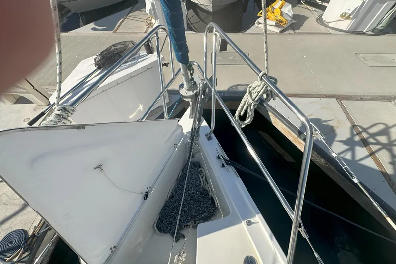 Slide: The Image of Bow of 2001 Catalina 28 MkII sailboat with open anchor locker and ropes. - 24