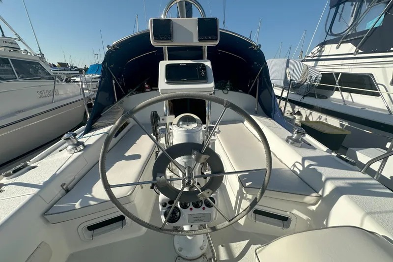 Slide: The Image of 2001 Catalina 28 MkII sailboat cockpit with steering wheel and navigation equipment. - 4