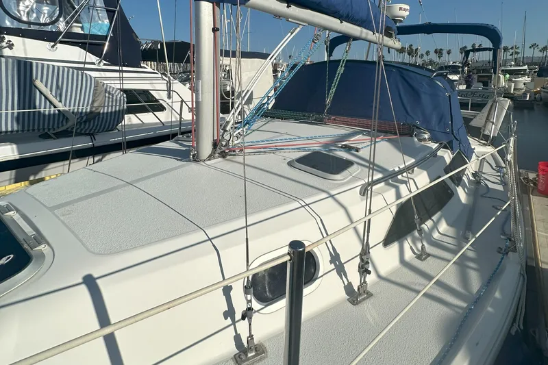 Slide: The Image of 2001 Catalina 28 MkII sailboat docked at marina, featuring blue canvas covers. - 6